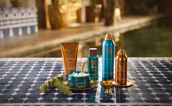 The Ritual of Hammam bath and body products arranged in a spa-like space, with blue packaging evoking freshness.