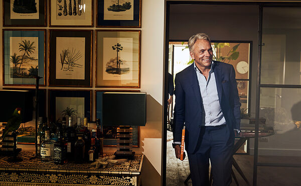 Rituals CEO Raymond Cloosterman smiling as he enters a warmly styled room filled with art and personal touches.