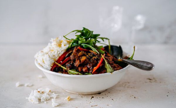 Bowl of vegetable stew with rice and greens, perfect for a nourishing healthy dinner.