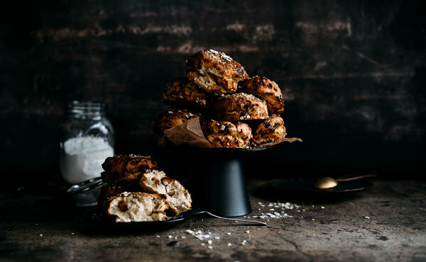 A stack of Medjool date and mandarin scones on a black stand, ready to enjoy as a comforting breakfast treat.