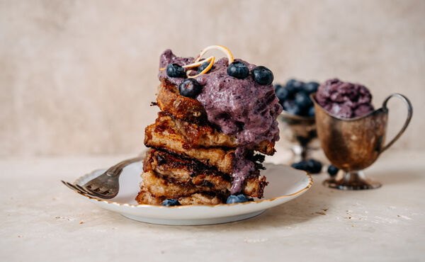 French toast stack with blueberry compote and fresh berries, a delicious and colourful breakfast dish.
