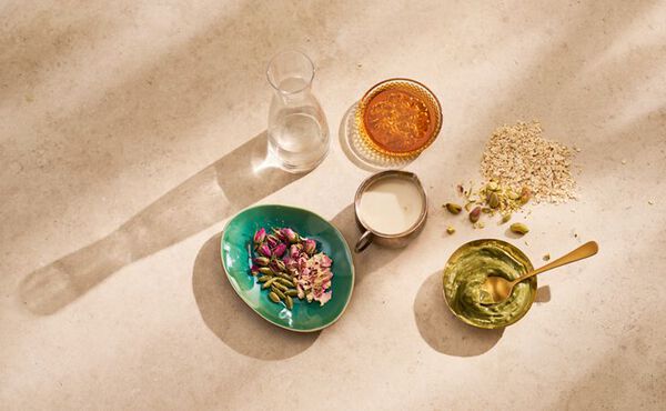Ingredients for pistachio coconut overnight oats recipe, including oats, spices, and milk.