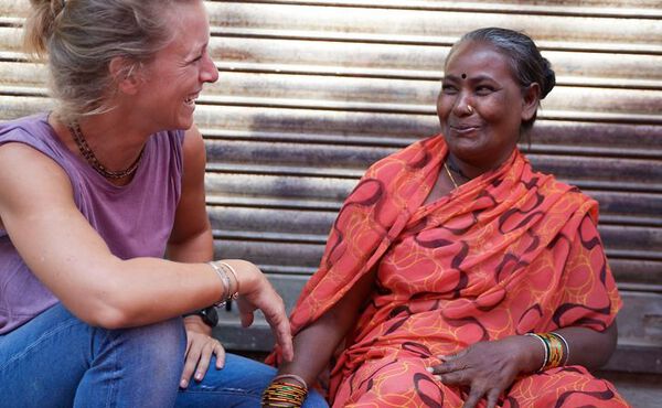 Laurien Meuter, founder of Tiny Miracles, smiling with a member of the Tiny Miracles foundation in Mumbai.